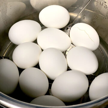 A dozen hard boiled eggs in the liner of an Instant Pot.