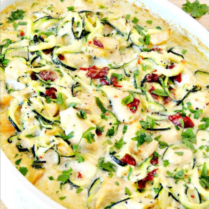 Chicken alfredo zucchini zoodle bake casserole in a white casserole dish.