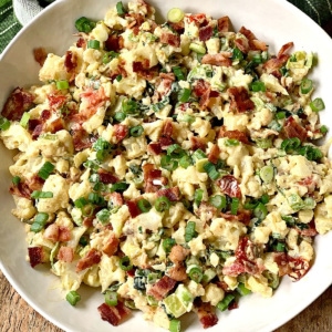 Overhead view of BLT Cauliflower Salad in a white serving bowl.