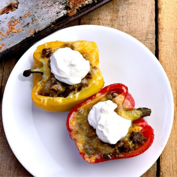 Low carb taco stuffed peppers on a white plate.