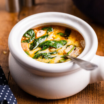 Low carb copycat Olive Garden zuppa toscana in a white bowl on a wooden table.