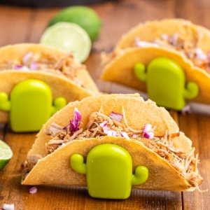 Three tacos in cactus taco holders made with keto flour tortillas.