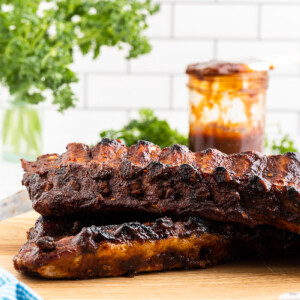 Keto oven baked BBQ ribs on a wooden cutting board.