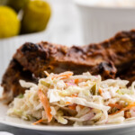 Low Carb Dill Pickle Coleslaw on a white plate with keto BBQ ribs.