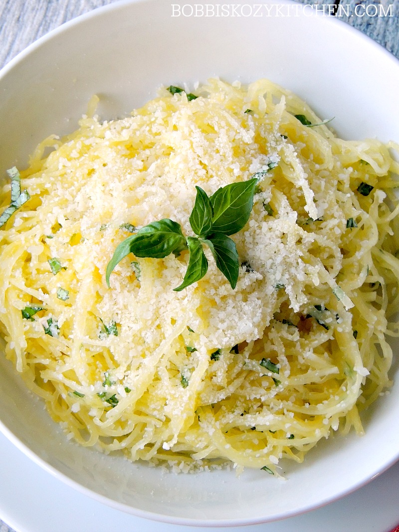 Close up of Herbed Spaghetti Squash with Garlic and Parmesan in a white bowl.