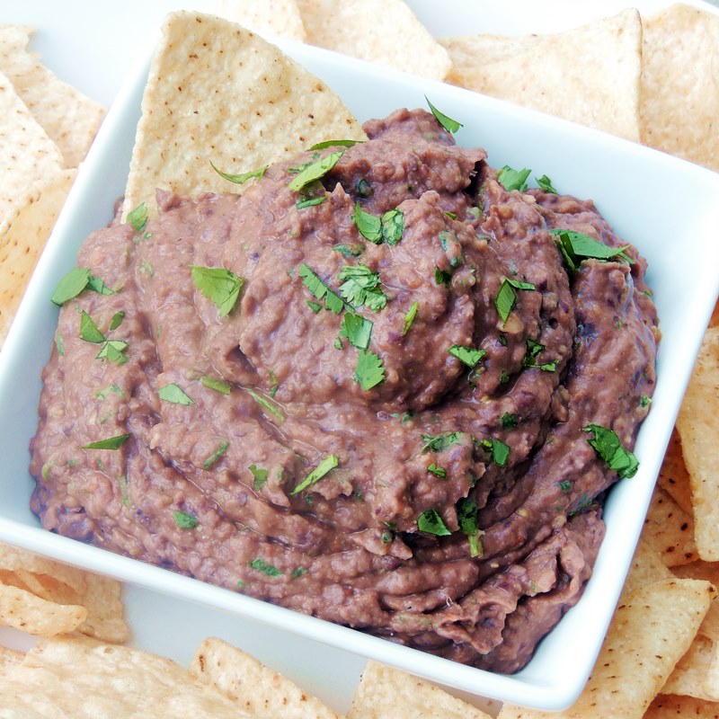 Chipotle black bean dip in a white bowl close up.