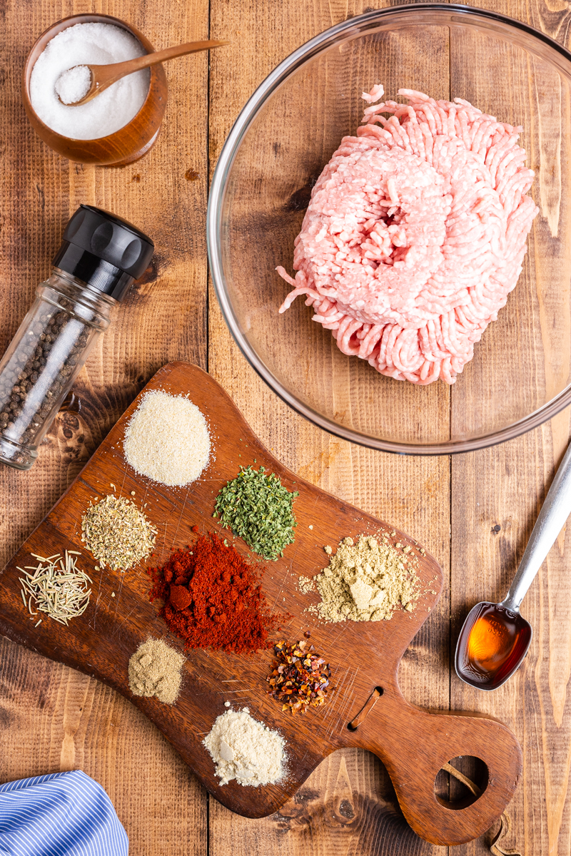Overhead photo of ingredients to make Keto Italian Sausage on a wooden table.