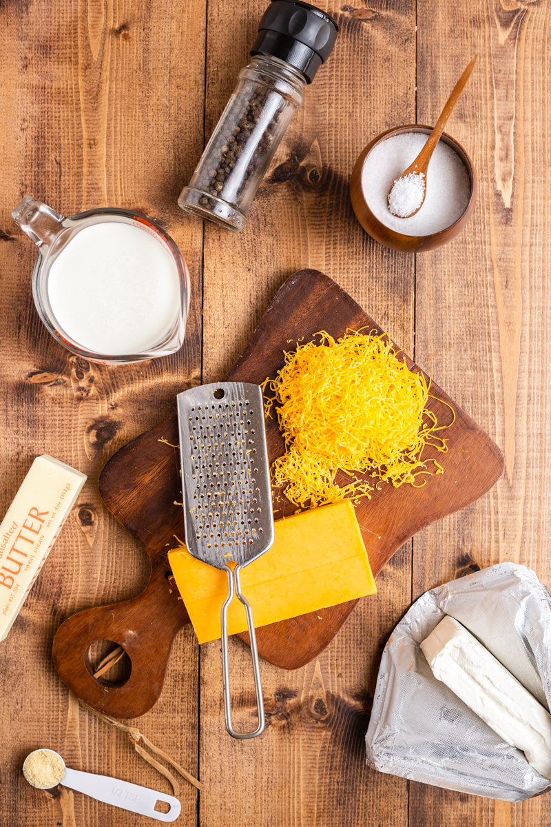 Over head photo of ingredients needed to make Easy Keto Cheese Sauce on a wooden table.