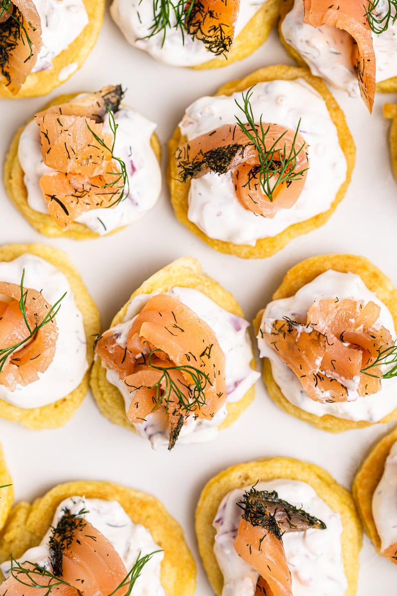 Clove up photo of Keto Blinis with Smoked Salmon Pate on a white platter.