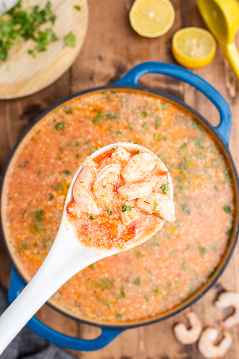 Overhead photo of Keto Brazilian Shrimp Stew in a large blue pot with a ladle full closer to the camera.