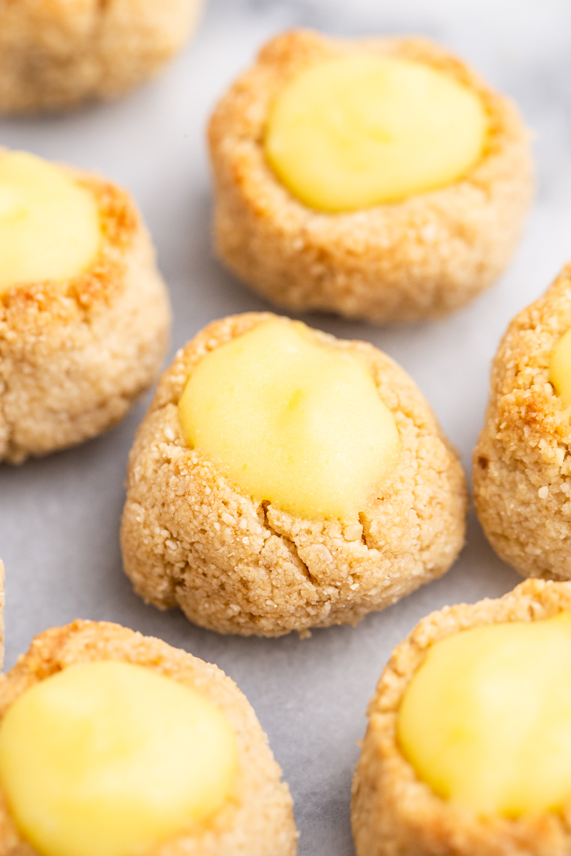 Close up photo of Keto Lemon Thumbprint Cookies on a marble counter top.