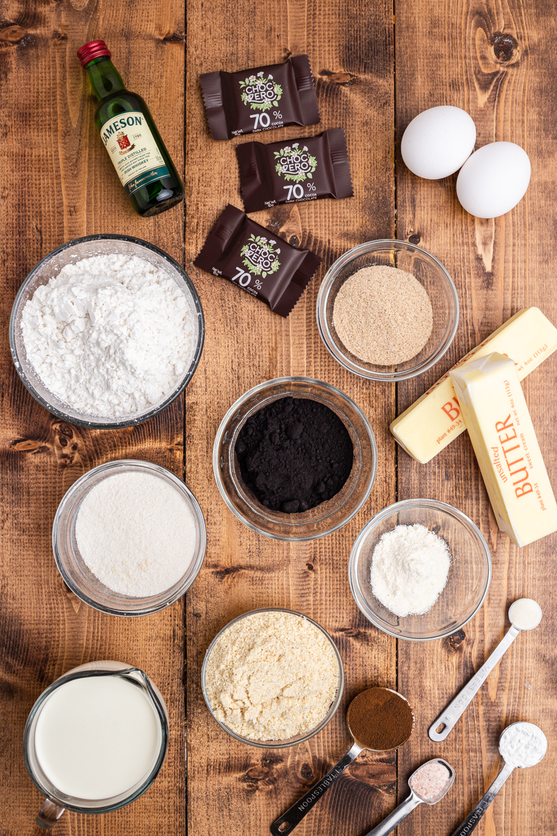 Overhead photo of the ingredients needed to make Keto Irish Coffee Cupcakes on a wooden table.