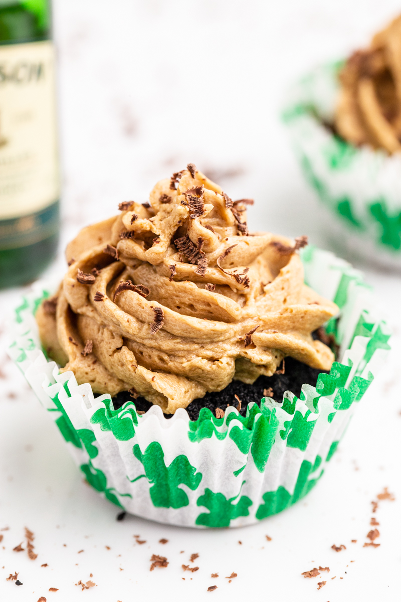 Closeup photo of a Keto Irish Coffee Cupcake in a St Patrick's Day cupcake wrapper.