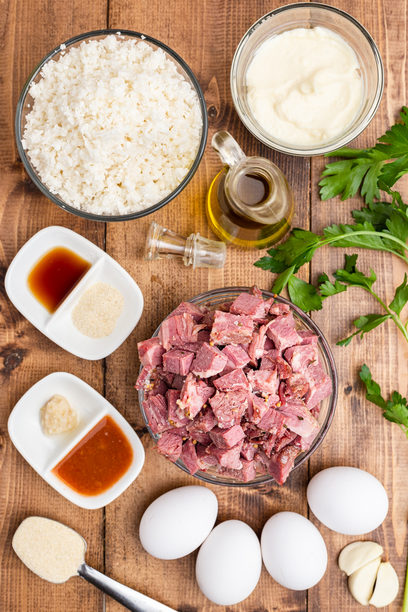 Photo of the ingredients needed to make Keto Corned Beef and Hash on a wooden table.