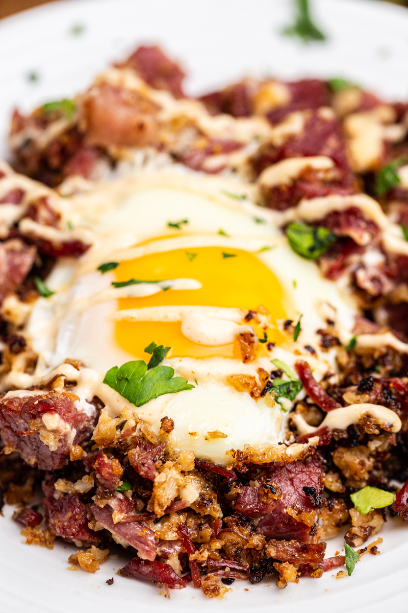 Closeup photo of a serving of Keto Corned Beef and Hash on a white plate.