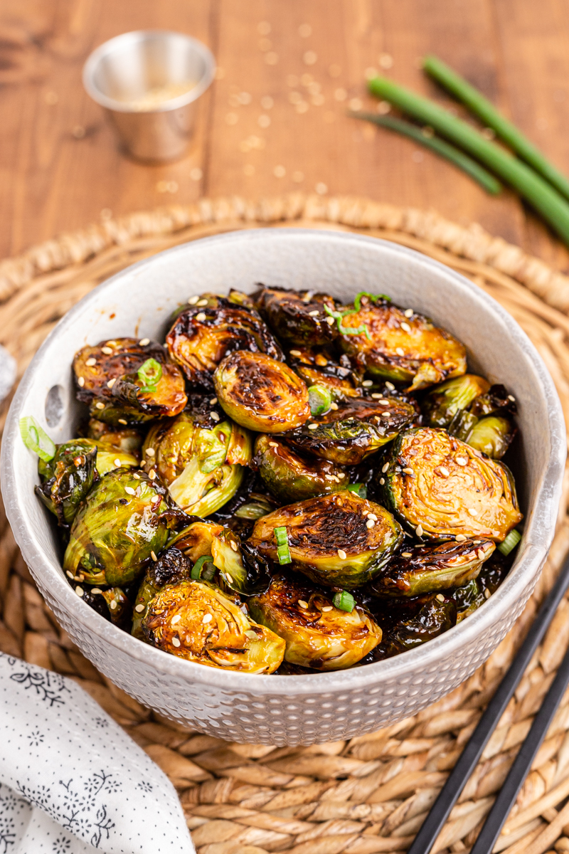 Photo of a white bowl full of Kung Pao Brussels Sprouts.
