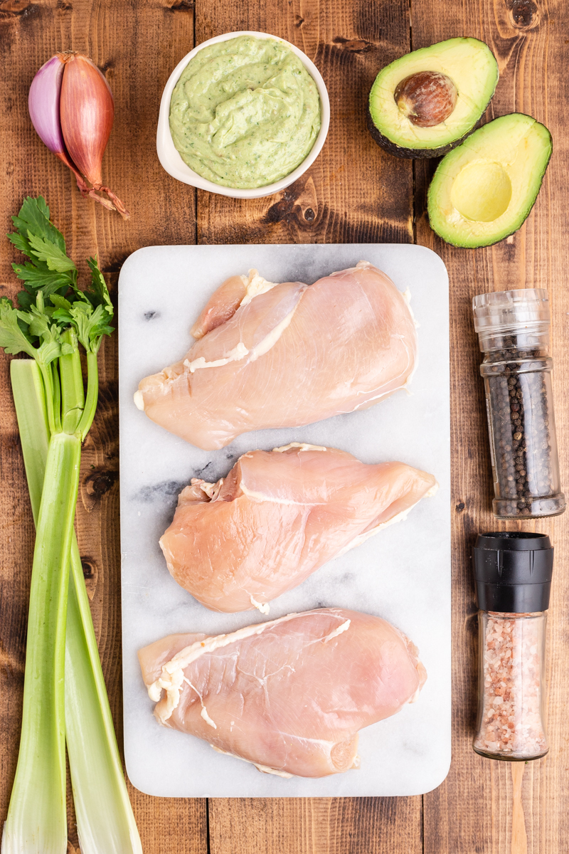 Photo of the ingredients needed to make Keto Avocado Ranch Chicken Salad on a wooden table.