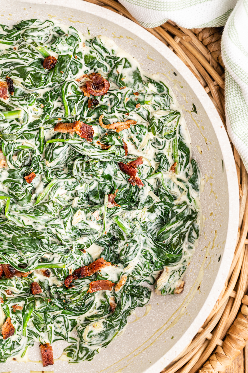 Overhead photo of Easy Creamed Spinach in a white skillet.