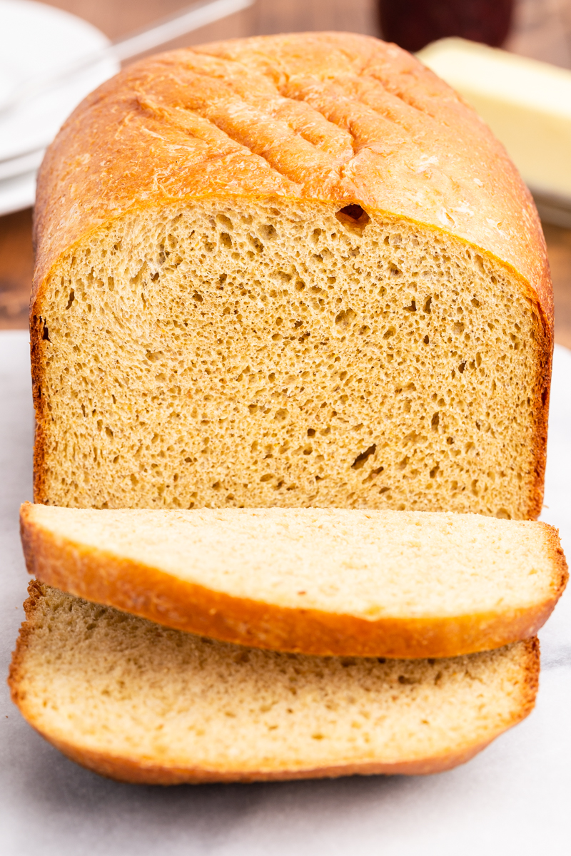 Closeup photo of a loaf of keto bread with 2 slices cut.