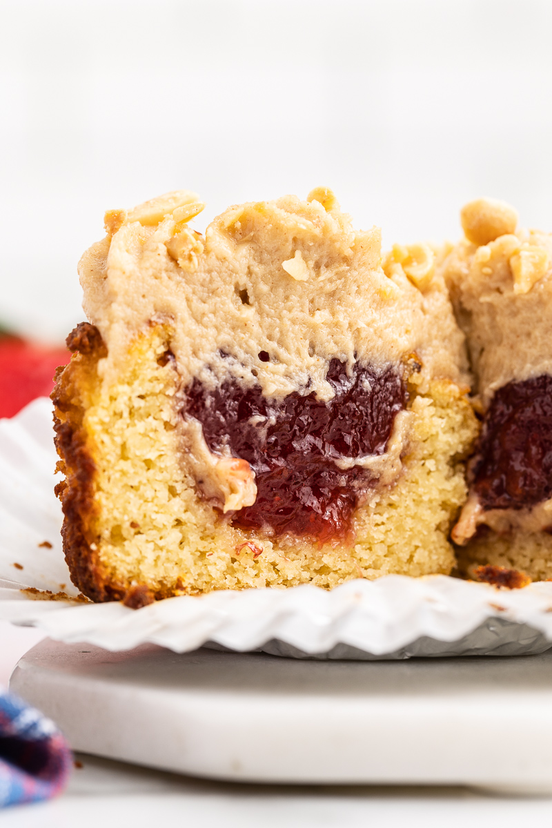 Closeup of a Keto Peanut Butter and Jelly Muffin cut in half to show the peanut butter and jelly inside.