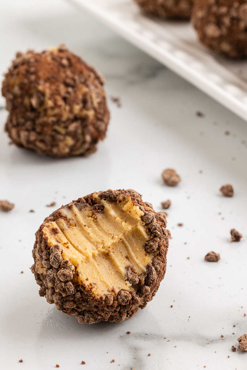 Photo of a Chocolate Peanut Butter Cheesecake Fat Bombs with a bite taken out of it.