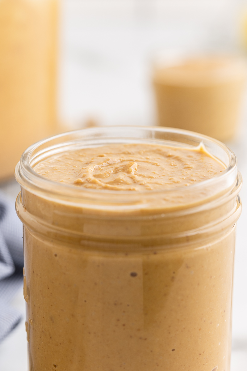 Closeup photo of Homemade Peanut Butter in a mason jar.