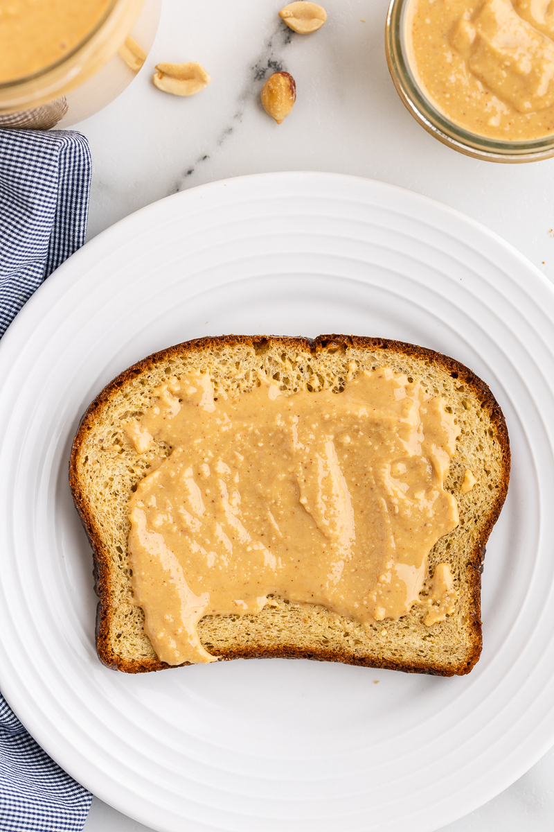 Overhead photo of Homemade Peanut Butter on a piece of keto bread.