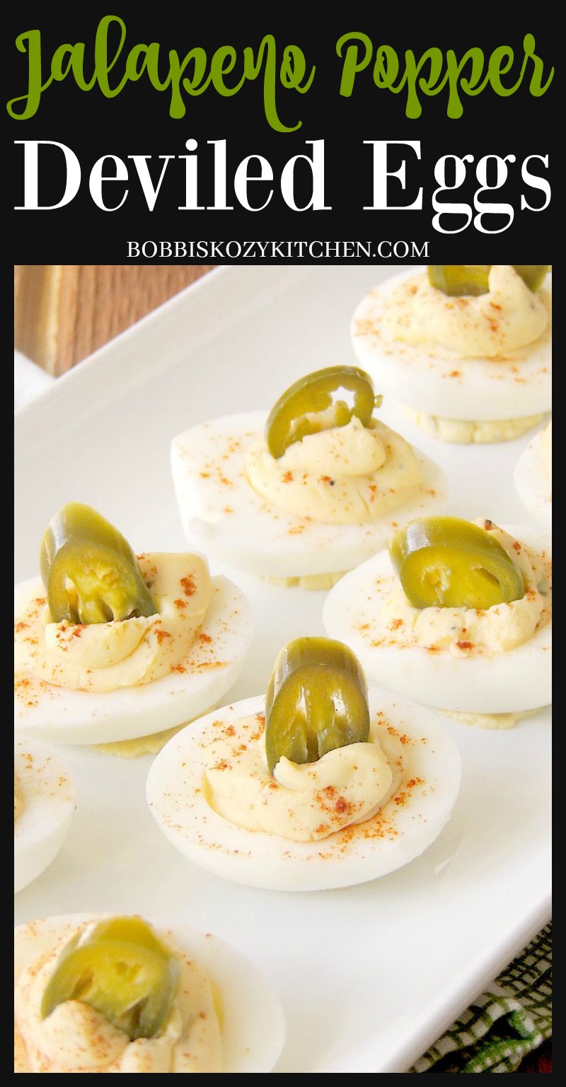 Close up of jalapeno popper deviled eggs on a white serving tray.