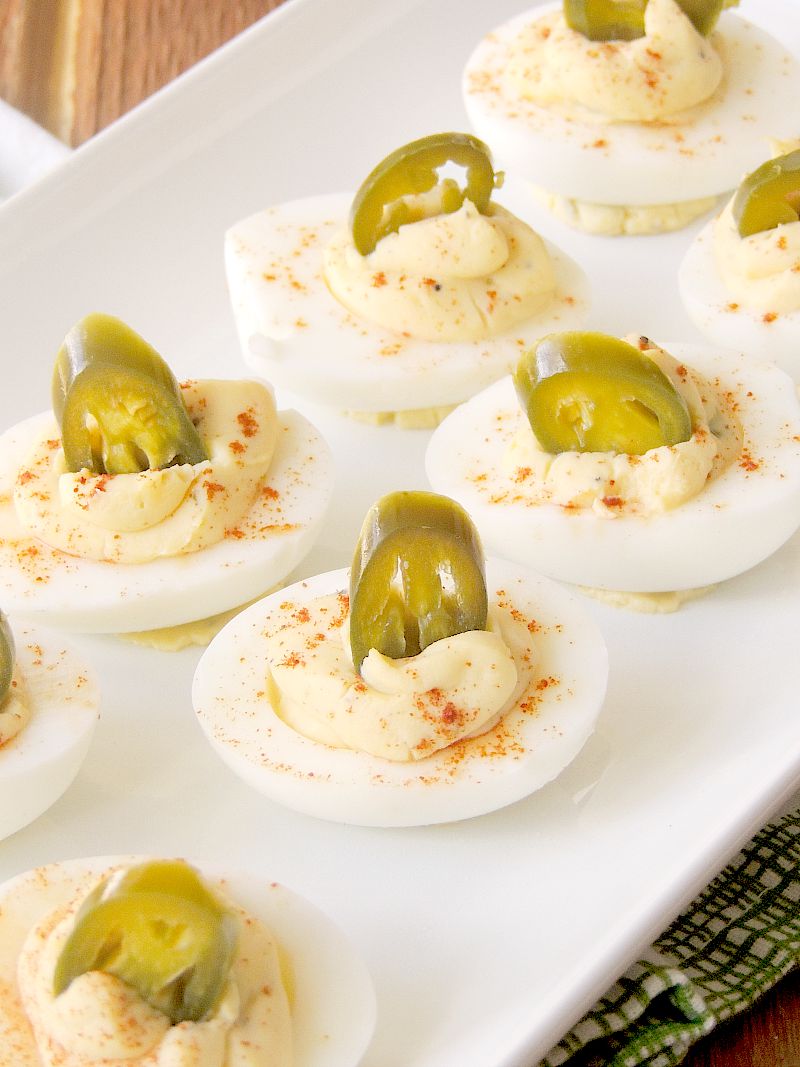 Closeup photo of Jalapeno Popper Deviled Eggs on a white serving tray.