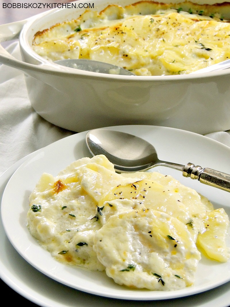 Julia Child's Gratin Dauphinois (Au Gratin Potatoes) are quite possibly my favorite potatoes ever! Potatoes, cream, cheese, and thyme? Heaven on a plate! #potatoes #thanksgiving #christmas #easter #sidedish #recipe | bobbiskozykitchen.com