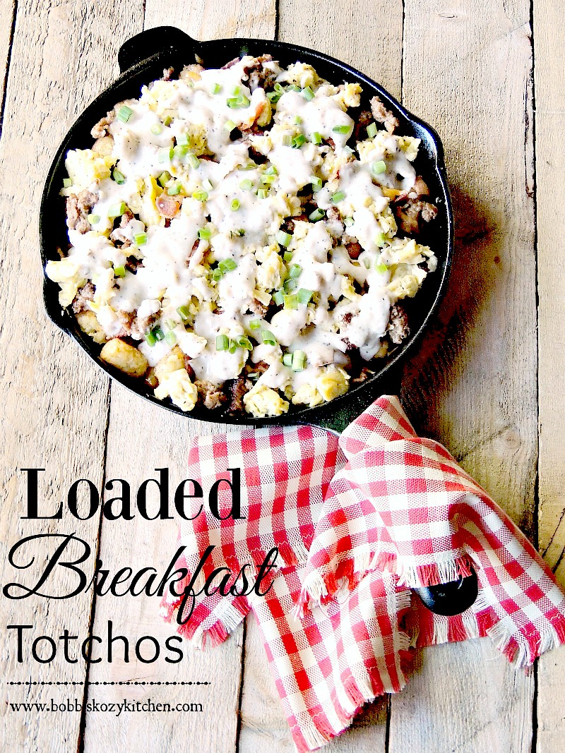 Loaded Breakfast Totchos are crispy tater tots layered with bacon, sausage, cheese, scrambled eggs, and country gravy www.bobbiskozykitchen.com