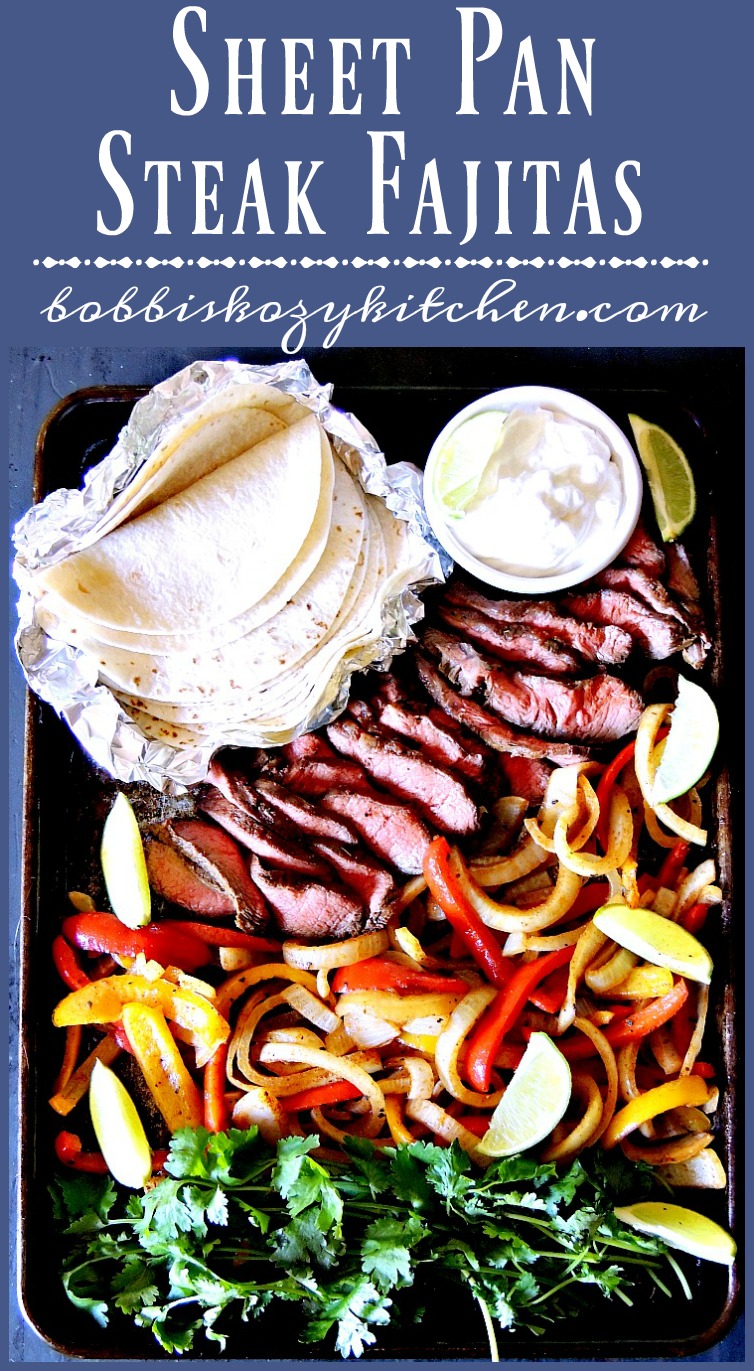 Overhead view of a sheet pan that contains keto tortillas, a small bowl of sour cream, sliced marinated steak, sliced bell peppers and onions, and fresh cilantro.
