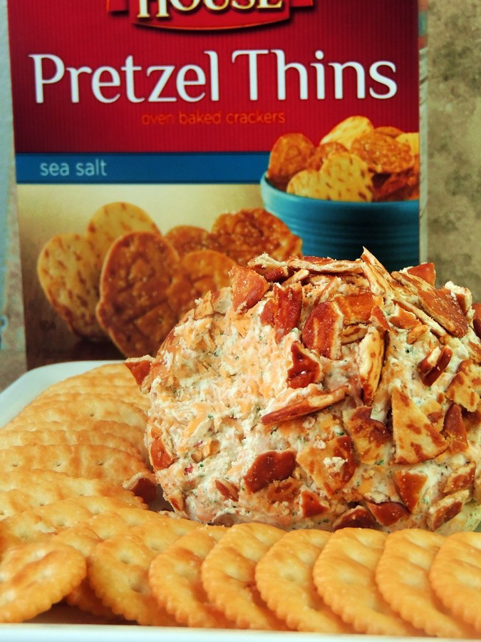 Buffalo Ranch Cheese Ball on a white platter with pretzel chips