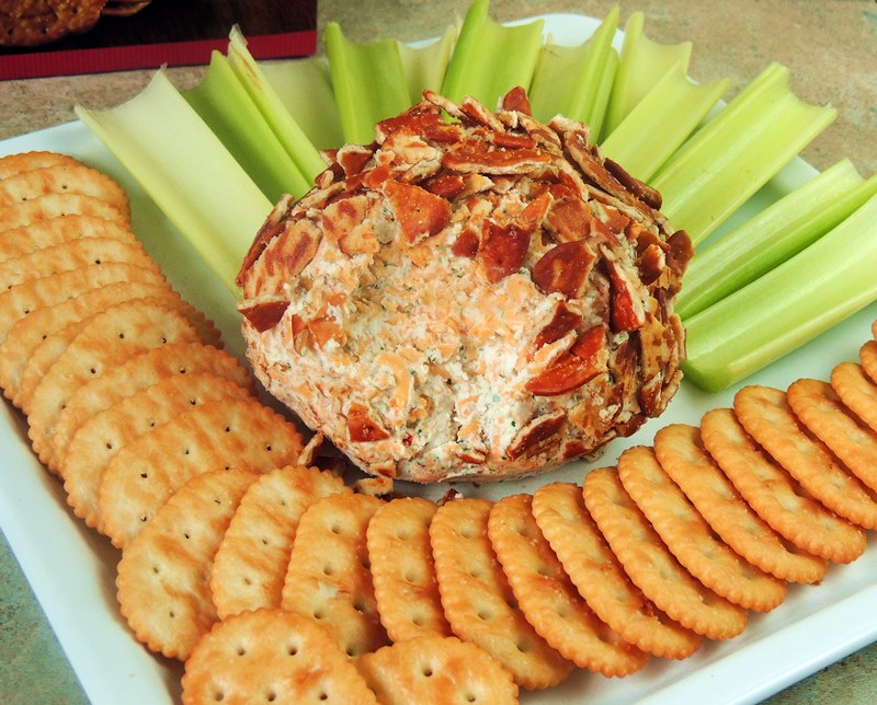 Buffalo Ranch Cheese Ball on a white platter with chips and veggies.