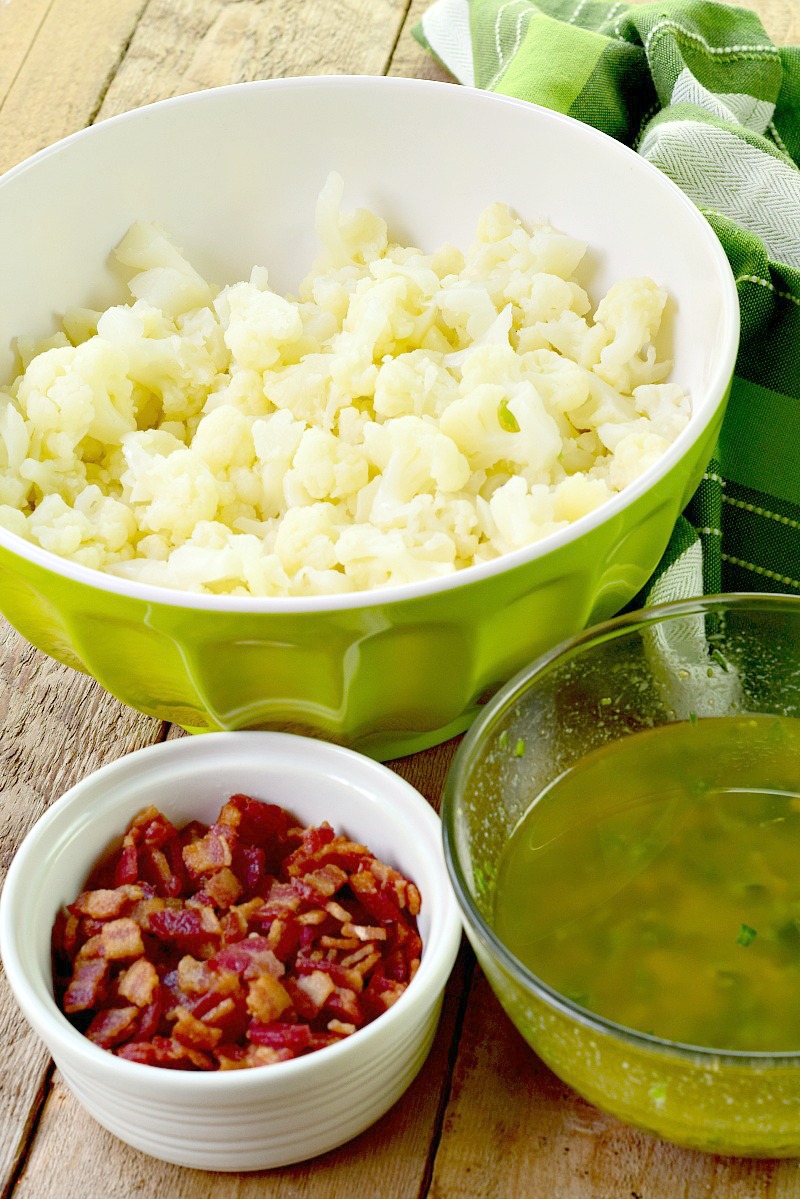 Cauliflower and Bacon Salad with Mustard Herb Vinaigrette  - This low carb and keto-friendly cauliflower salad recipe is easy to make and sure to become a favorite side for all of your barbecues, picnics, and summer parties! Light and bright, it is chock full of herbs, and with zero mayo, it is perfect for the dairy-free crowd too! #keto #lowcarb #dairyfree #cauliflower #salad #sidedish #easy #recipe | bobbiskozykitchen.com