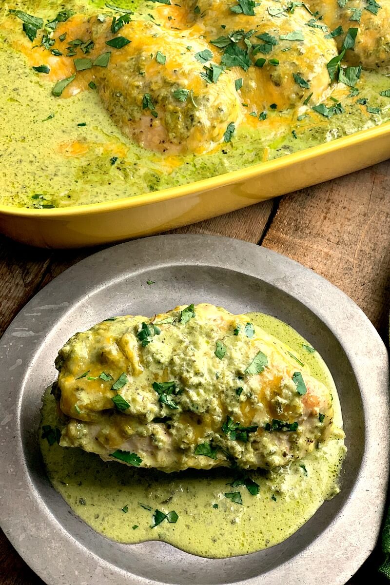 Baked Green Chile Chicken - This Baked Green Chili Chicken recipe is an easy and delicious low carb and keto-friendly dinner filled with spice, cheese, and a creamy green chili sauce. #Mexican #chicken #lowcarb #keto #glutenfree #chickenbreast #chickenthighs | bobbiskozykitchen.com