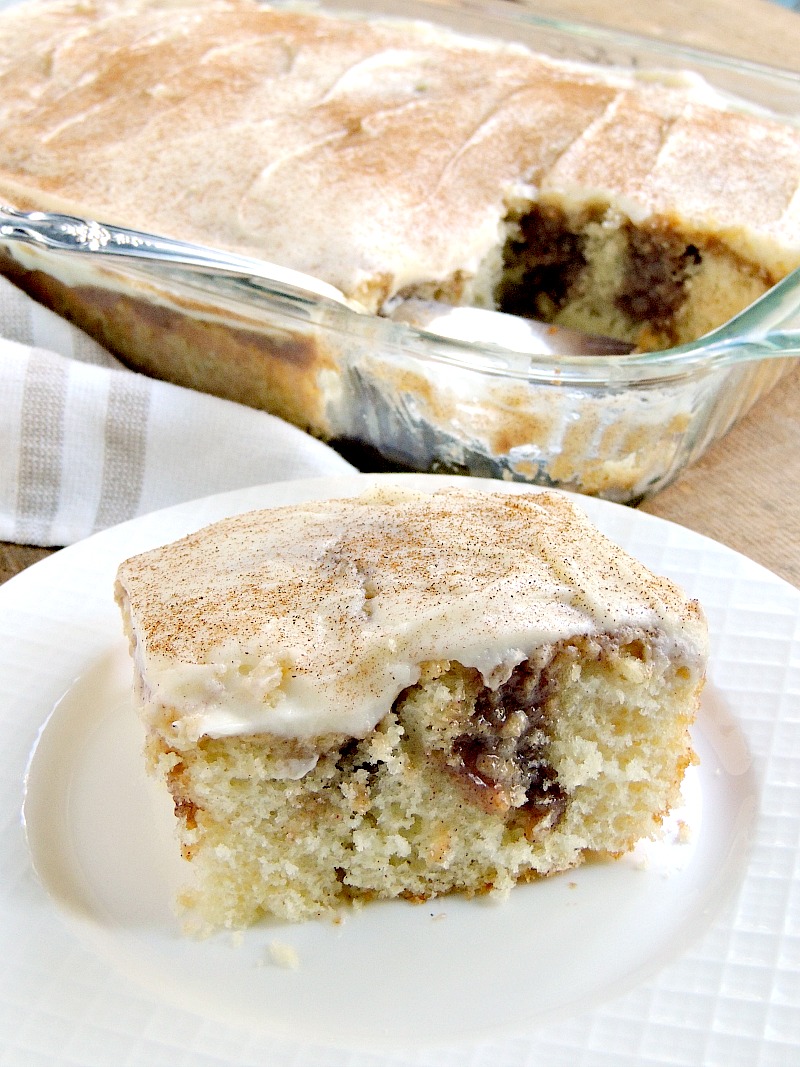 This Cinnamon Roll Poke Cake has all of the flavors of a cinnamon roll and is so moist and tender it melts in your mouth! From www.bobbiskozykitchen.com