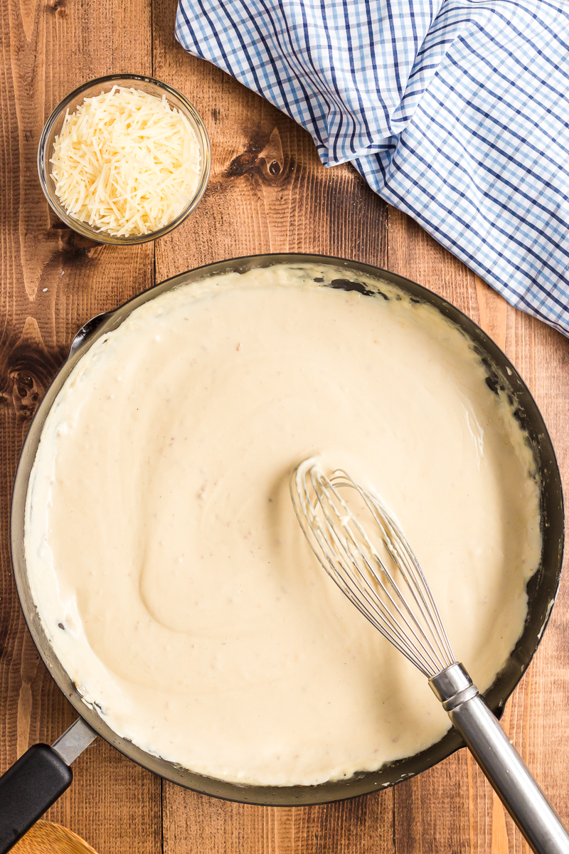 This creamy keto Alfredo Sauce is very low-carb and gluten-free. Loaded with garlic, Parmesan cheese, and just a touch of nutmeg. #glutenfree #lowcarb #keto #glutenfree #parmesan #cream #sauce #Italian #recipe #olivegarden #easy | bobbiskozykitchen.com