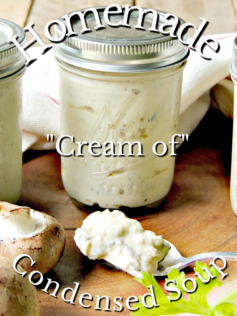 Homemade condensed cream of mushroom, celery, and chicken soup in mason jars on a wooden cutting board.