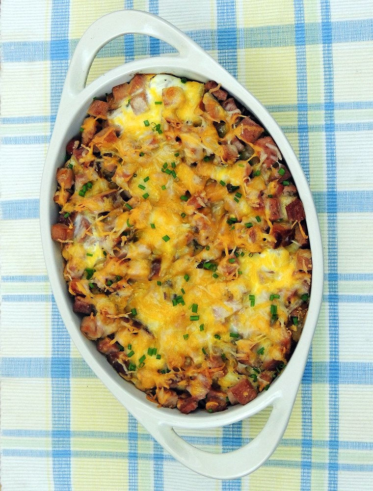 overhead view of Make-Ahead Ham and Cheese Breakfast Casserole in a white casserole dish.