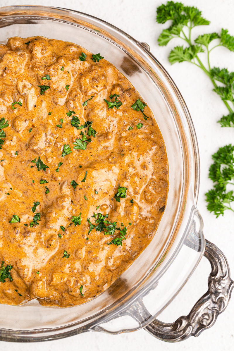 Overhead close up photo of Instant Pot Ground Beef Stroganoff in a glass serving dish.