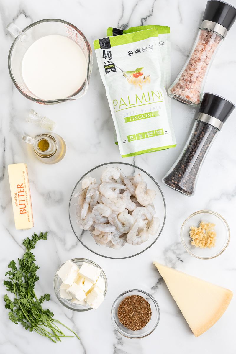 Overhead photo of the ingredients needed to make Keto Cajun Shrimp Alfredo on a marble countertop.