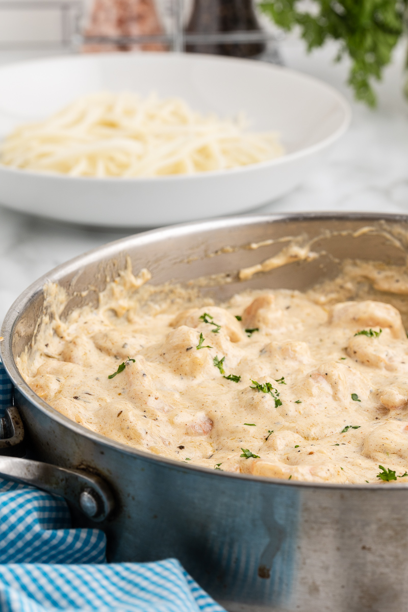 Closeup photo of a stainless steel pan with Keto Cajun Shrimp Alfredo inside.