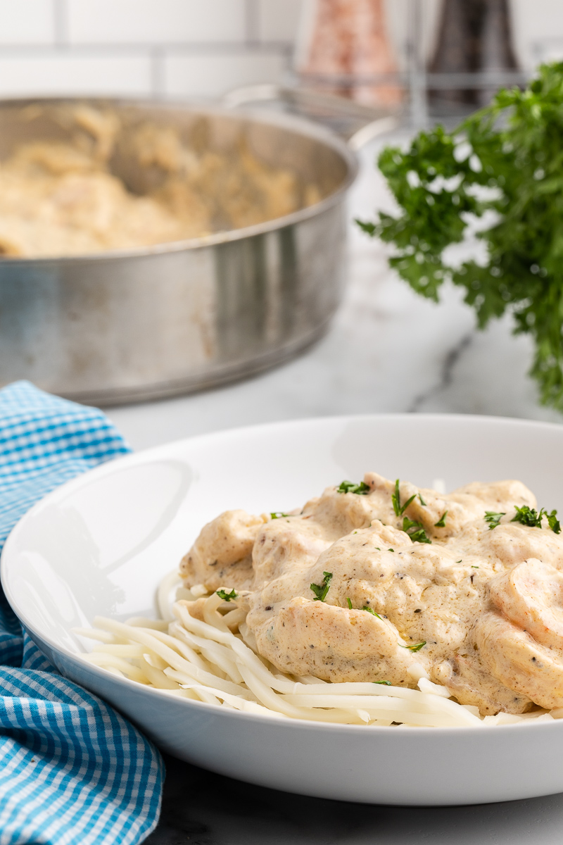 Closeup photo of Keto Cajun Shrimp Alfredo in a white bowl.