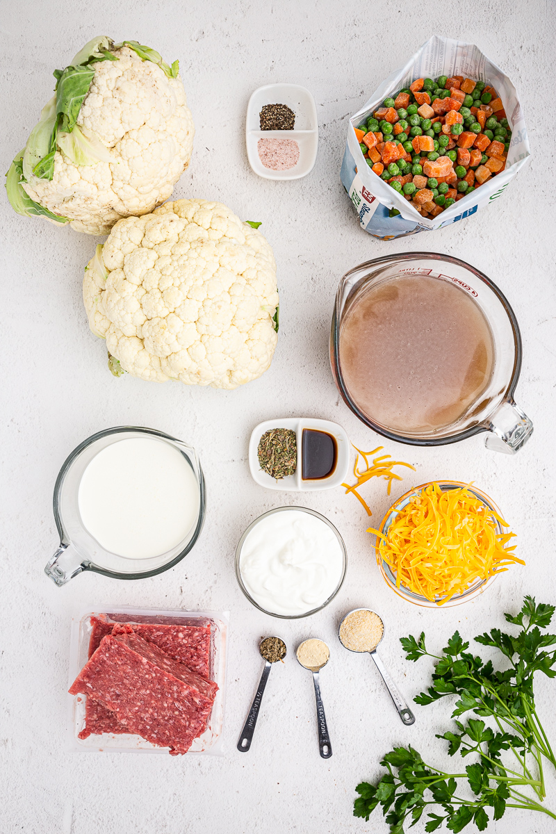 Overhead photo of the ingredients needed to make Low Carb Shepherds Pie Soup on a marble counter.
