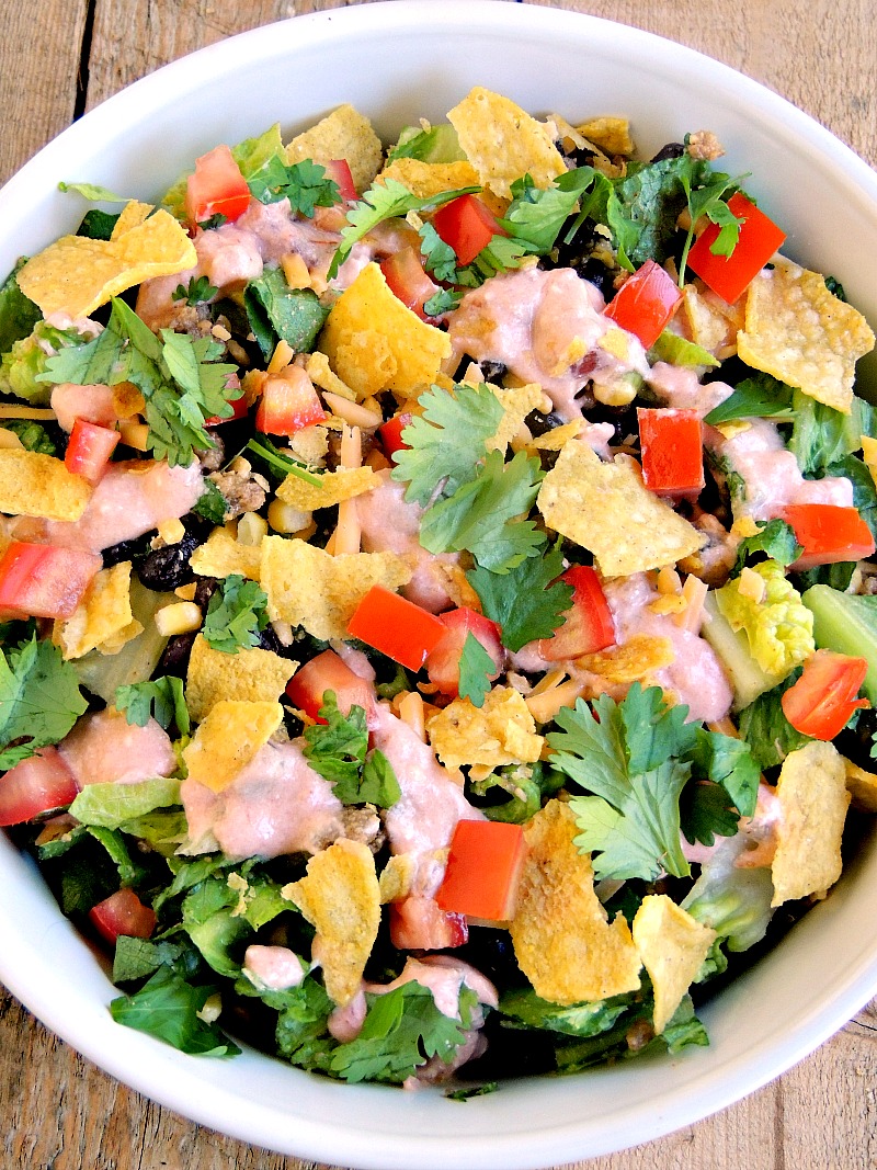 This Nacho Salad, made with chicken and Greek yogurt, is a healthy alternative to the high calorie snacking favorite. From www.bobbiskozykitchen.com