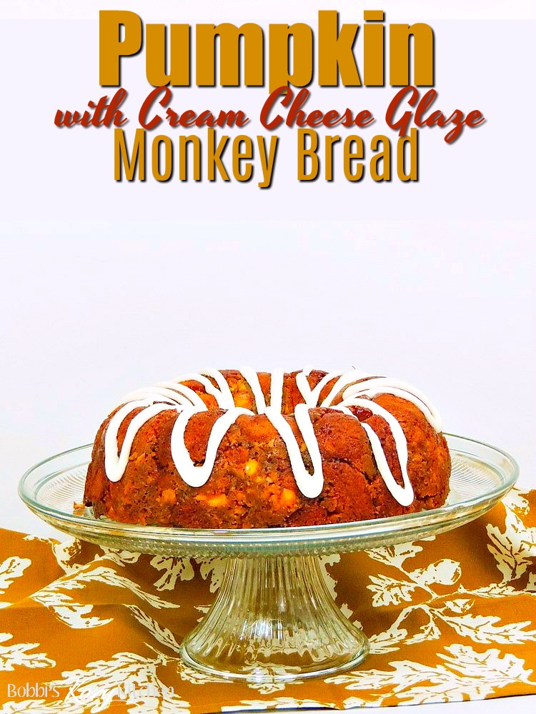 This Pumpkin Monkey Bread recipe is easy to make, full of delicious pumpkin flavor, and topped with a decadent cream cheese glaze. #pumpkin #bread #cake #monkey #easy #recipe #cheese | bobbiskozykitchen.com