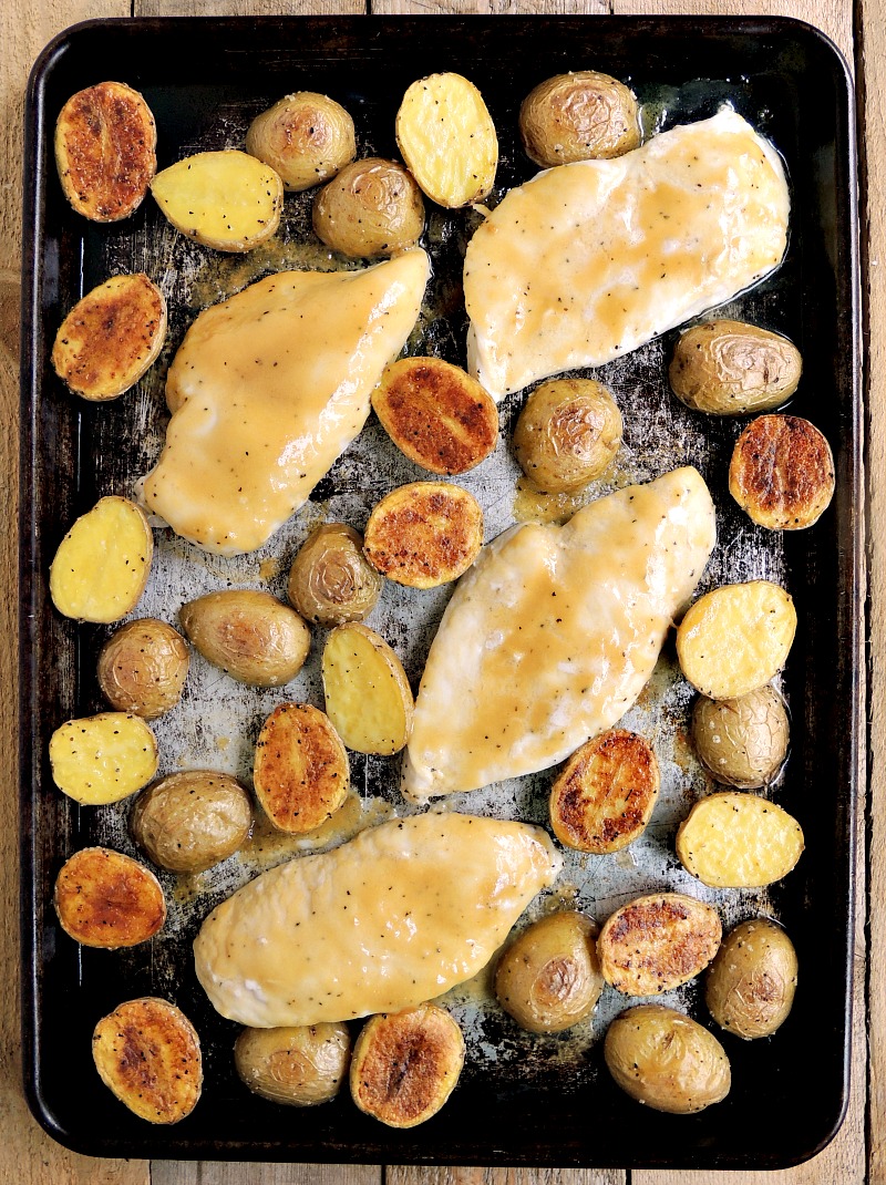Honey mustard chicken and potatoes on a sheet pan.