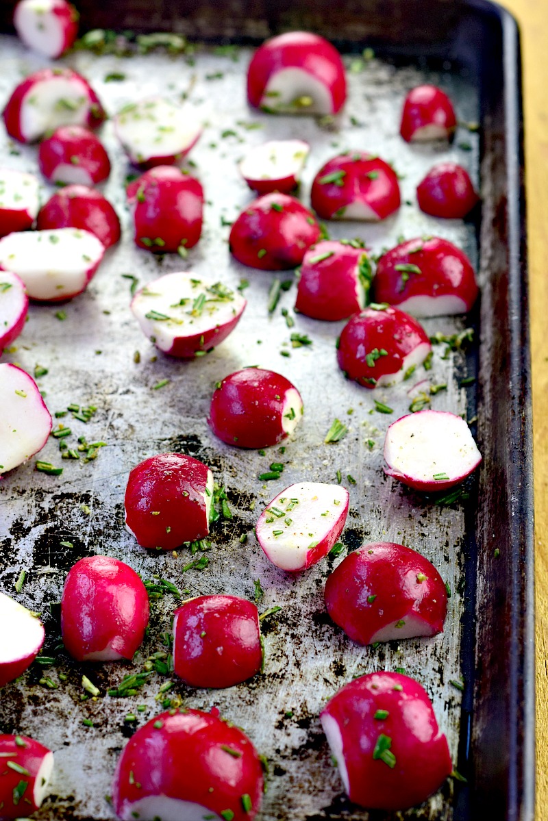 Halved radishes on a sheet pan.