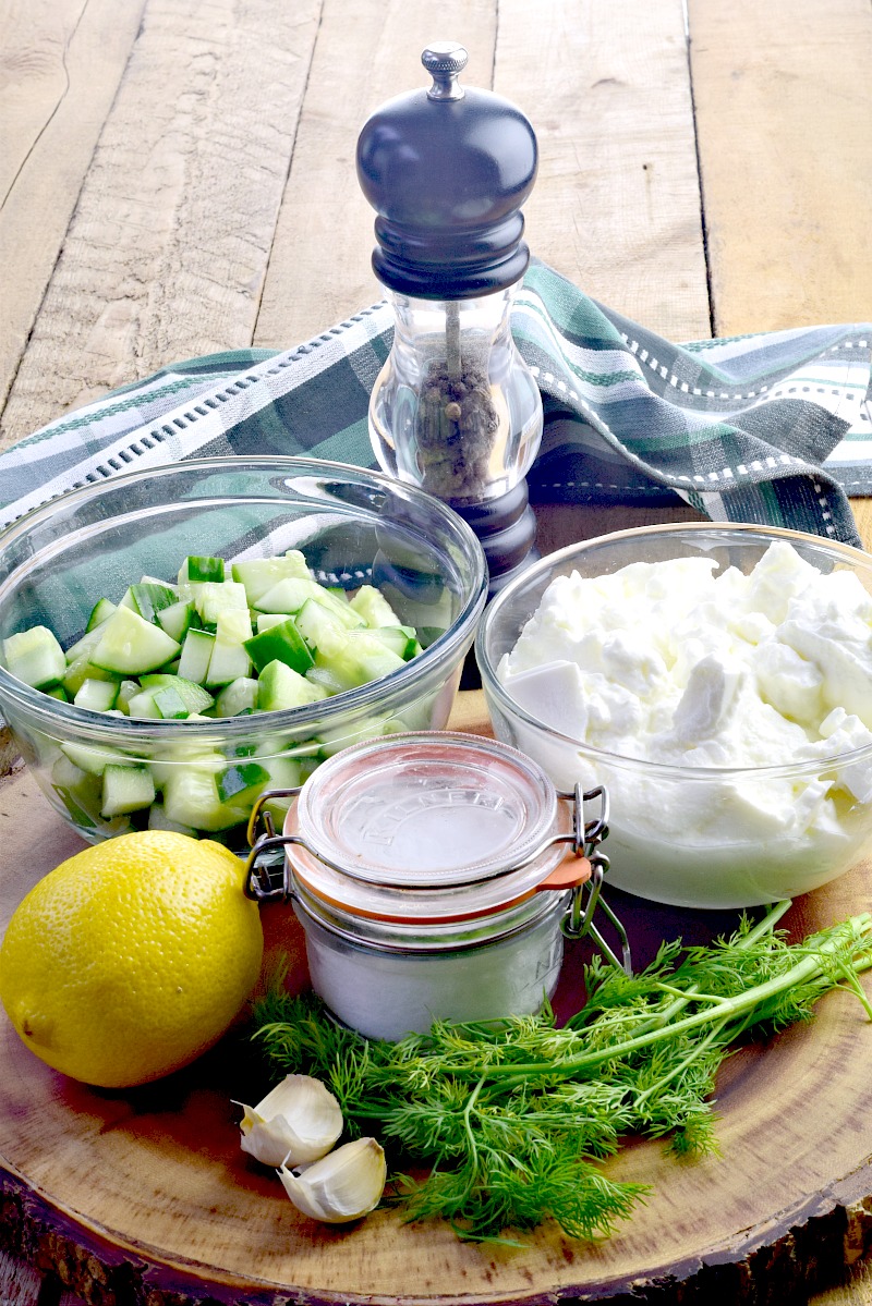 Authentic Greek Tzatziki Sauce Recipe - This Tzatziki Sauce recipe is so full of flavor, creamy and delicious, and ridiculously easy to make with just 5 ingredients, plus salt and pepper.  Naturally low carb and keto-friendly, this sauce is extremely versatile, adding a punch of authentic Greek flavor to everything from burgers and sandwiches, to salads, and veggies, and of course, is the perfect sauce for gyros, souvlaki, and so much more! #Greek #sauce #condiment #cucumber #dill #greekyogurt #lowcarb #keto #glutenfree #sugarfree #easy #recipe | bobbiskozykitchen.com
